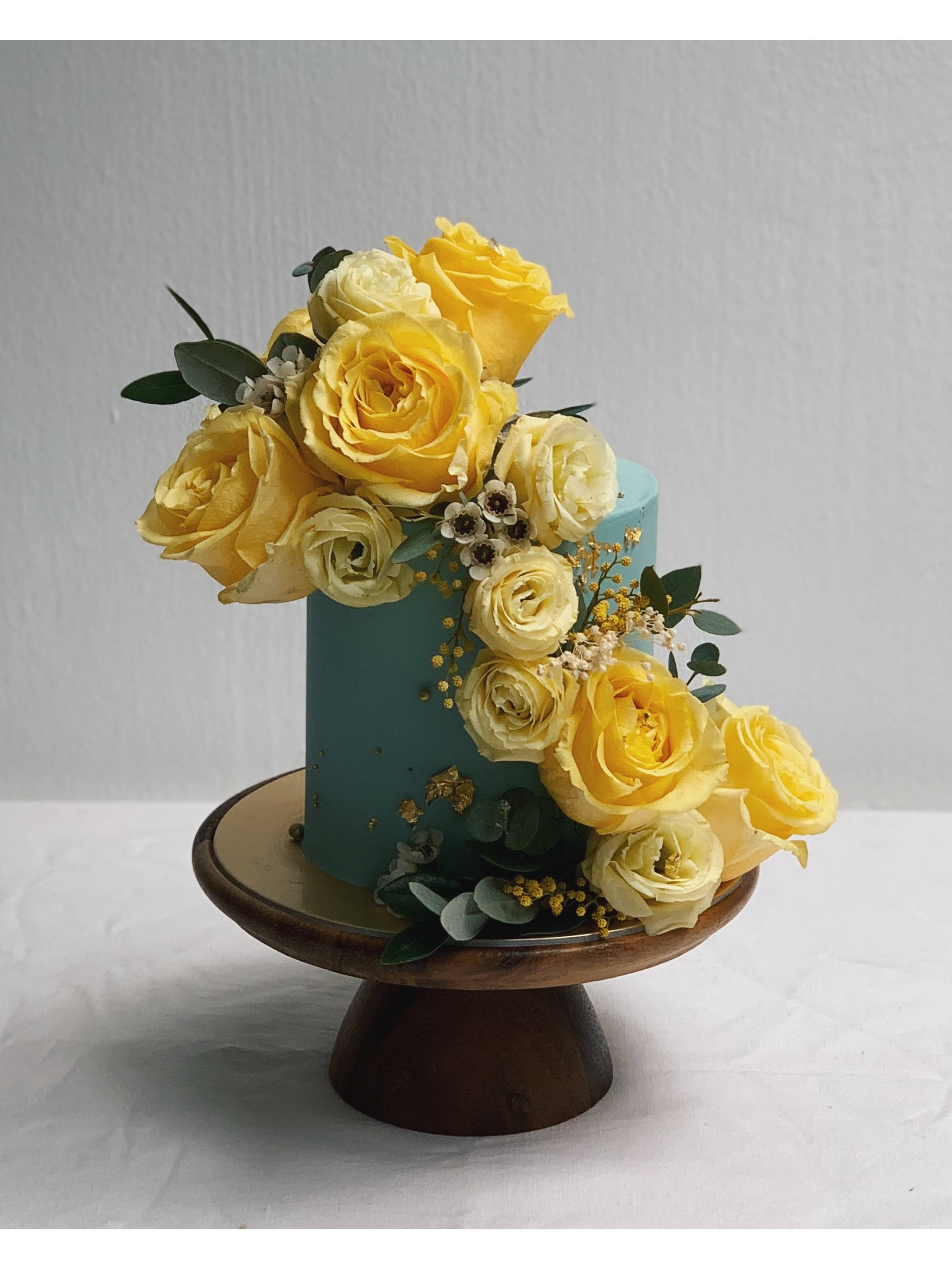 F22. Dusty Blue Cascading Yellow Floral Cake