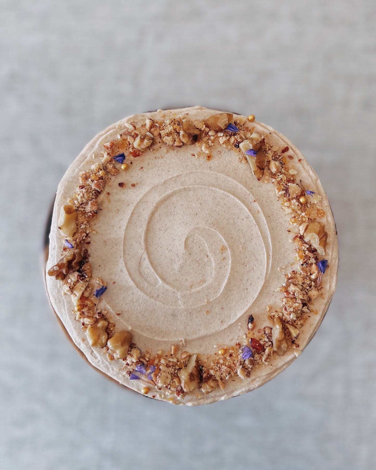 top view of carrot walnut cake with textured frosting Singapore